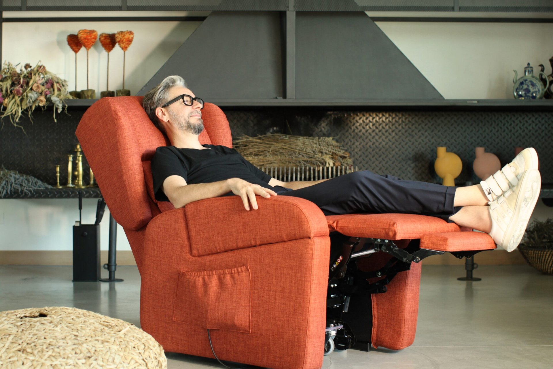 Man reading in a reclined electric care chair at home