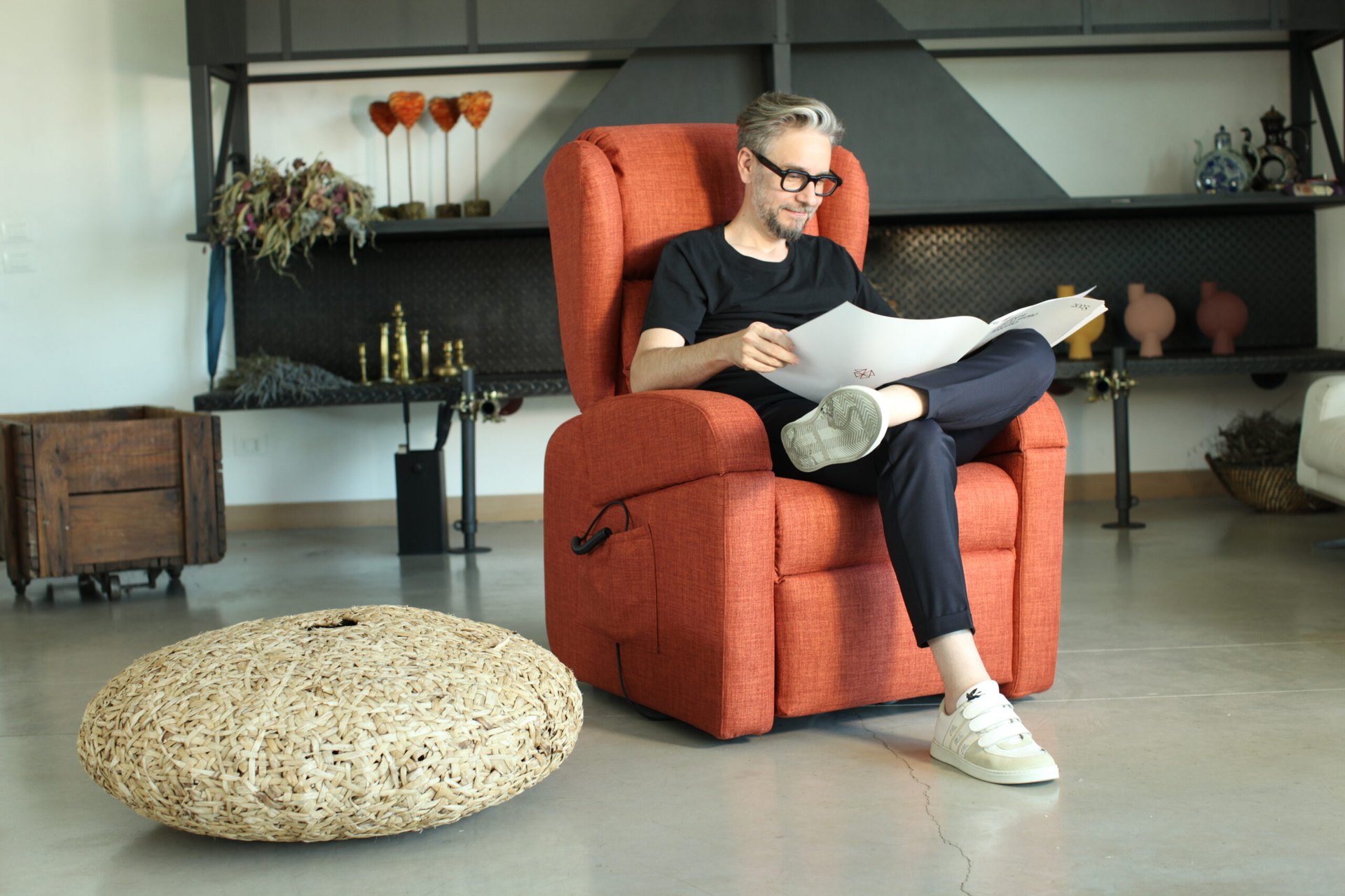 Woman reading a newspaper in an electric recliner at home